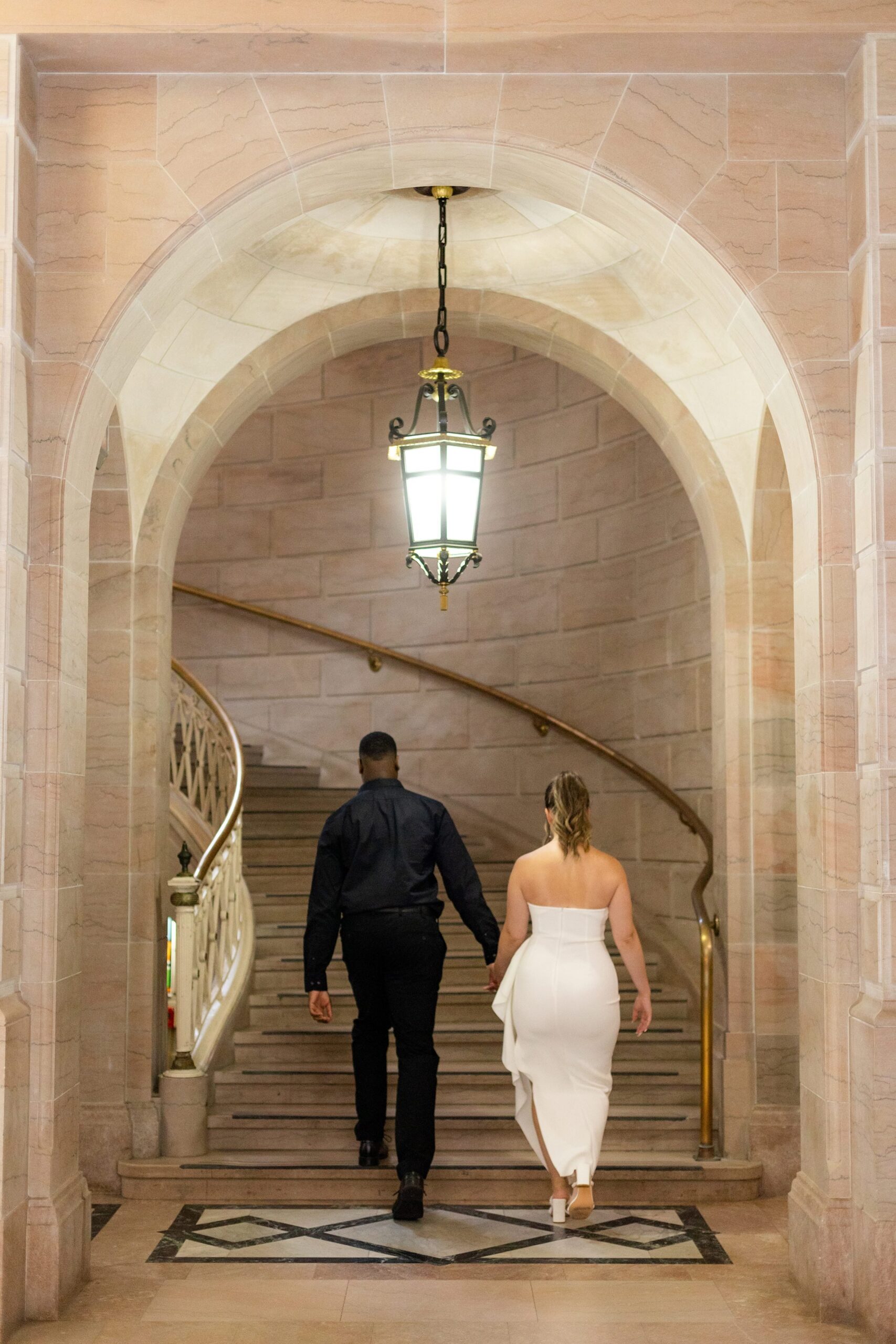 Couple walking up the stairs hand in hand