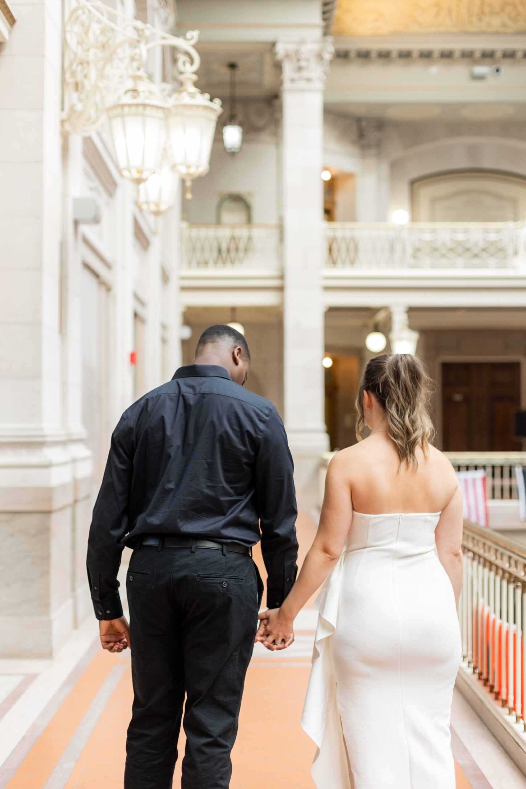 Couple walking hand in hand at City Hall