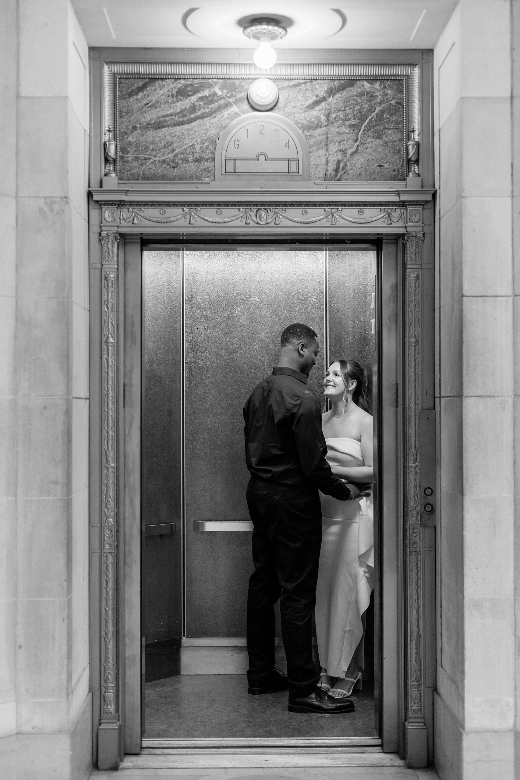 Couple kissing in historic elevator at Hartford City Hall