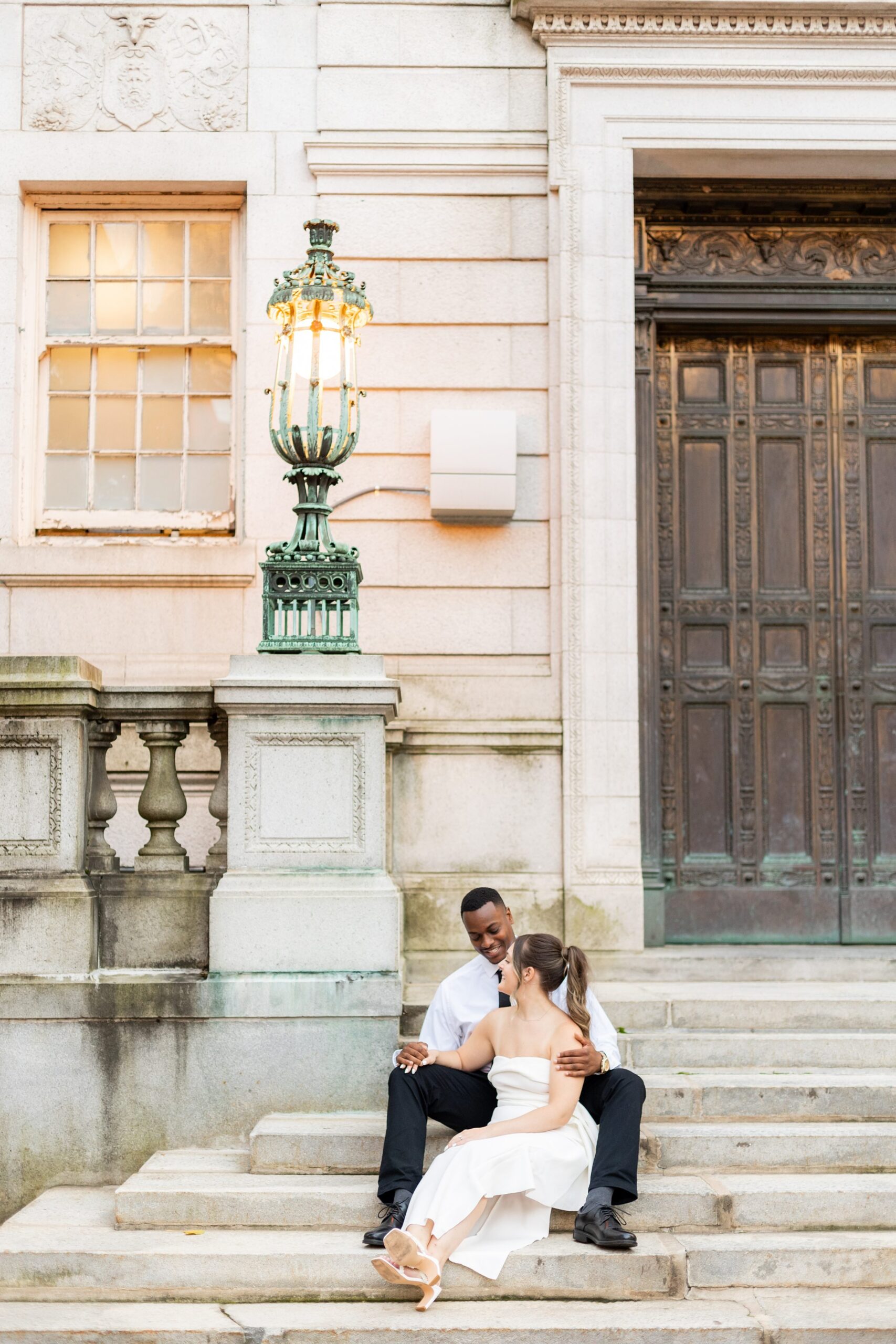 Couple sitting outside on staircase at Hartford City Hall