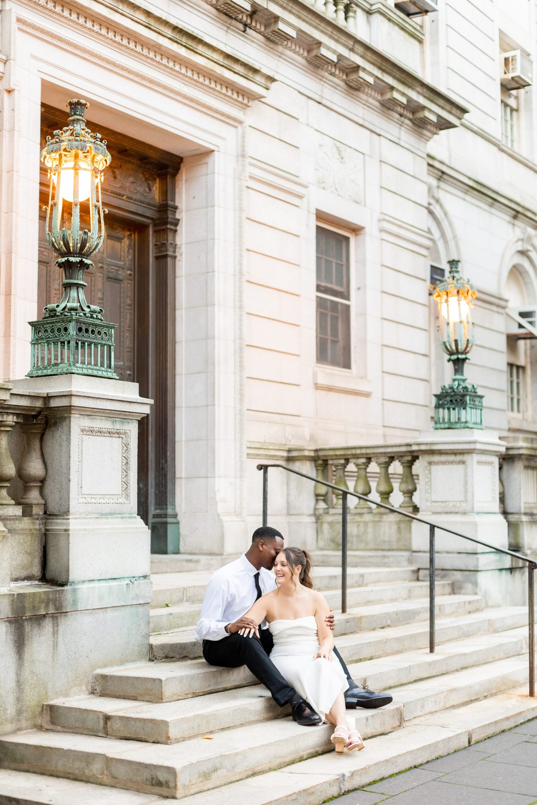 Couple sitting outside on staircase at Hartford City Hall