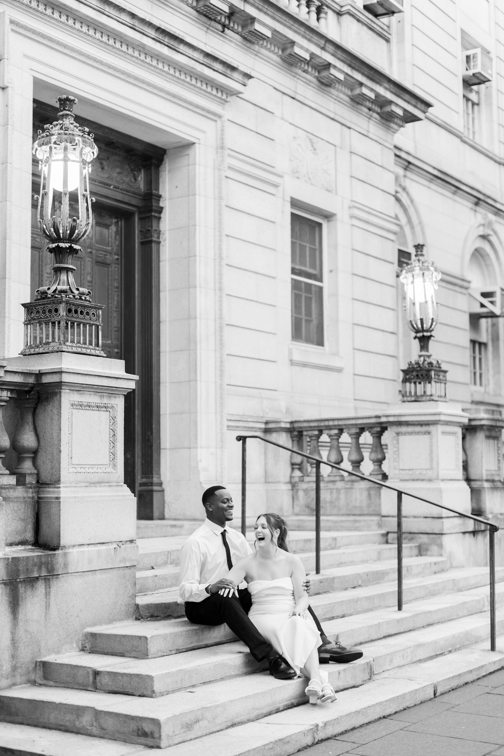 Couple sitting outside on staircase at Hartford City Hall